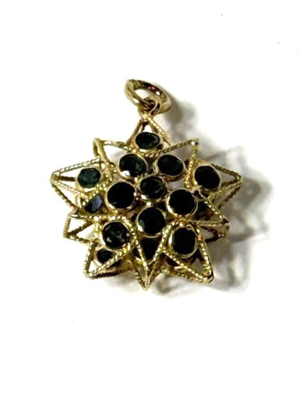 14K yellow gold double sided star-shaped blue sapphire pendant.